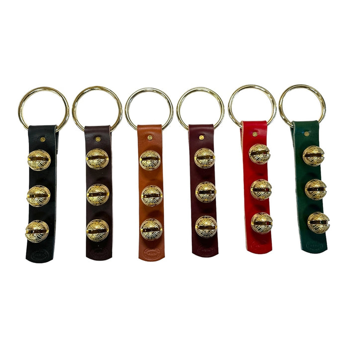 Set of six keychains with leather straps and gold accents on a white background