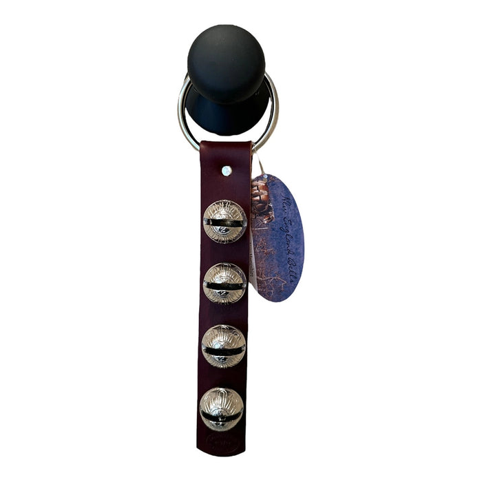 Black bell with leather strap and metal bells on a white background