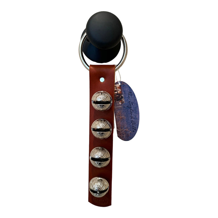 Keychain with leather strap, black ball, and metal buttons on a white background