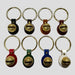 Set of keychains with gold bell designs on a white background