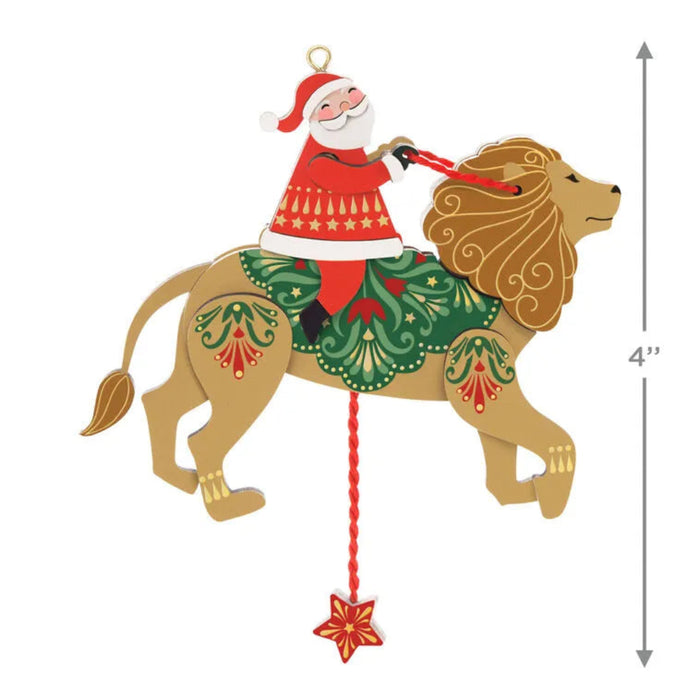 Decorative ornament of Santa Claus riding a lion with Christmas-themed decorations, size indicated.
