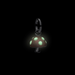 Mushroom-shaped pendant with glowing green spots on a black background