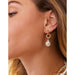 Model wearing Spartina 449 Starfish Groupie Earrings with pearl drop and gold starfish detail