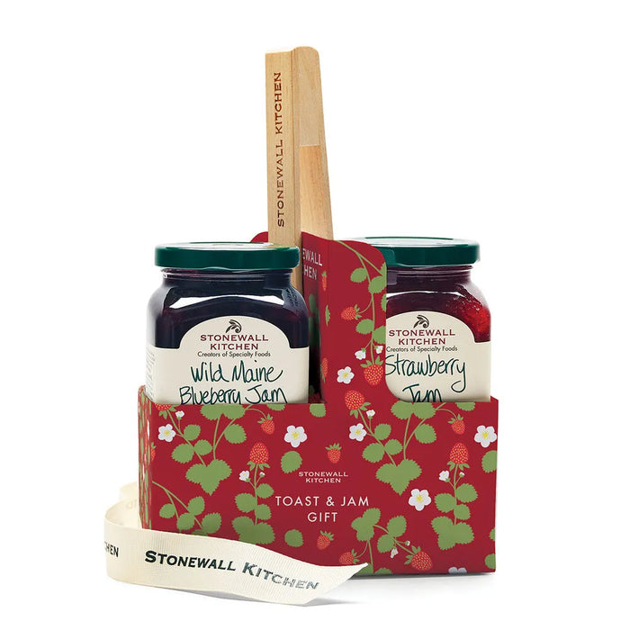 Stonewall Kitchen jam set with two jars and a wooden spreader in a decorative carrier on a white background.