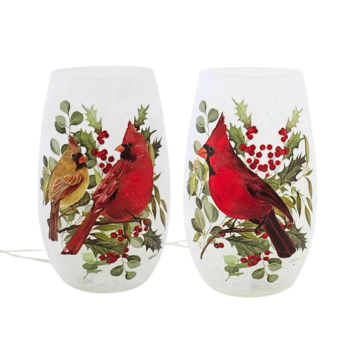 Two assorted Stony Creek pre-lit small vases featuring red cardinals with holly and greenery on frosted glass.