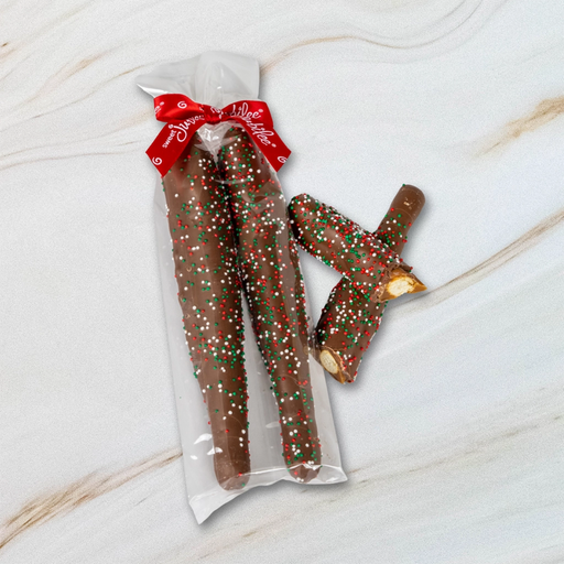 Sweet Jubilee Holiday Milk Chocolate Covered Caramel Pretzel Rods in clear bag with red ribbon.