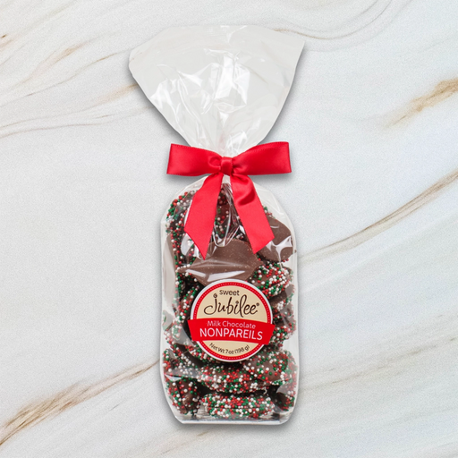 Sweet Jubilee Holiday Milk Chocolate Nonpareils in clear bag with red bow – festive chocolate gift.