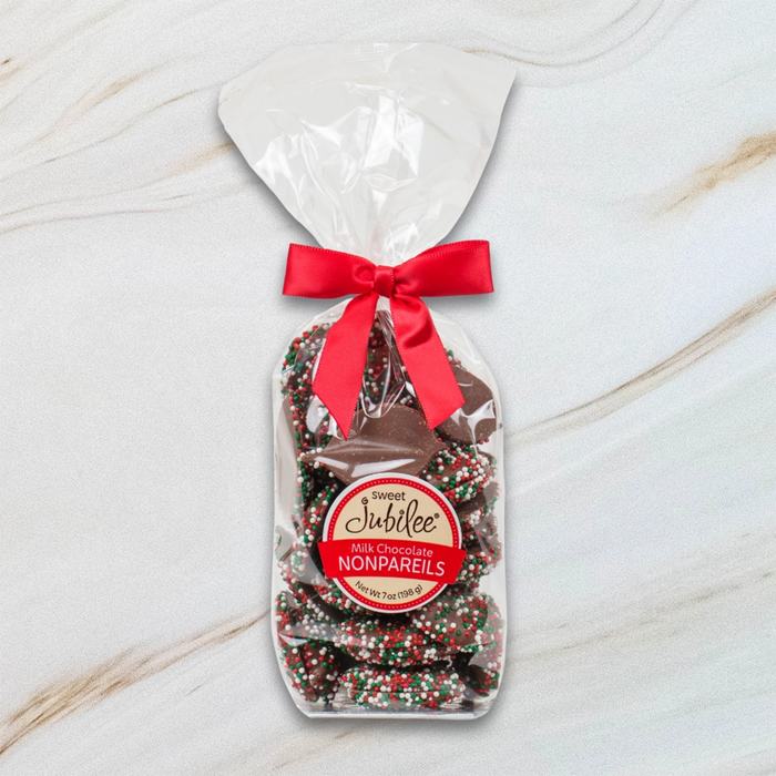 Sweet Jubilee Holiday Milk Chocolate Nonpareils in clear bag with red bow – festive chocolate gift.