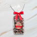 Sweet Jubilee Holiday Milk Chocolate Nonpareils in clear bag with red bow – festive chocolate gift.