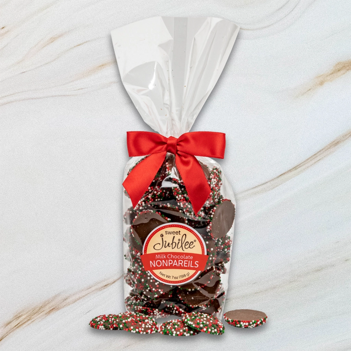 Bag of Sweet Jubilee Milk Chocolate Nonpareils with holiday sprinkles – perfect Christmas treat.