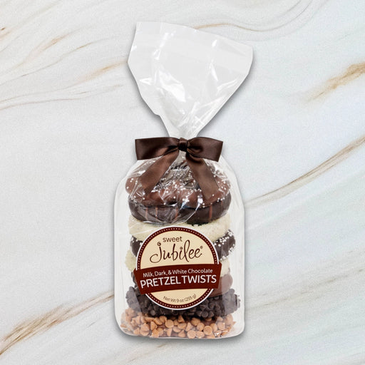Sweet Jubilee Pretzel Stack Gift Bag with milk, dark, and white chocolate covered pretzel twists tied with brown satin ribbon.