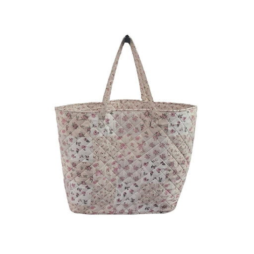 A pink and white floral tote bag featuring a vibrant flower pattern on a sturdy fabric.