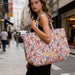 A decorative tote bag with a lively, colorful pattern, highlighting a spectrum of vibrant colors and artistic elements.