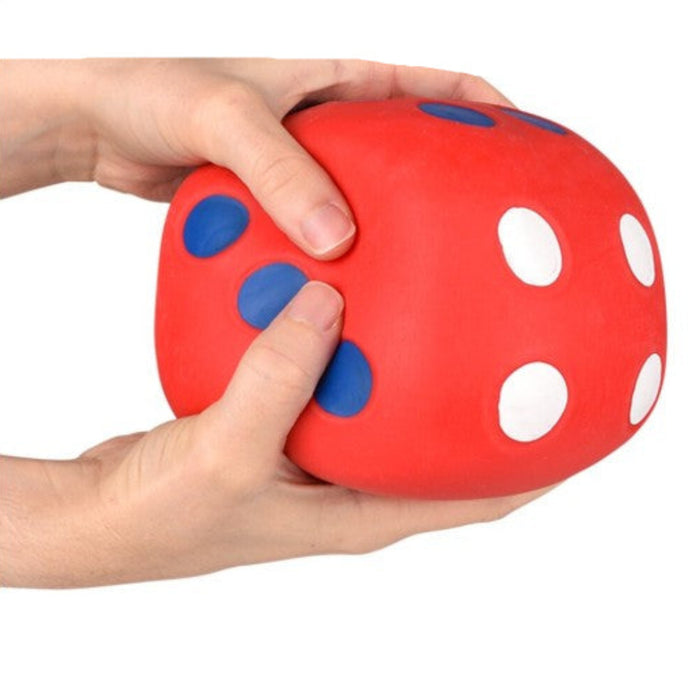 Red stress ball with blue and white spots held by a hand, 'Out of Stock' label visible.