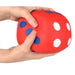 Red stress ball with blue and white spots held by a hand, 'Out of Stock' label visible.
