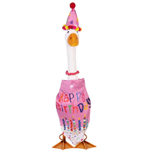 A cheerful duck dons a birthday hat while standing on a grassy lawn, ready for a celebration.