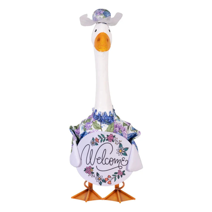 A duck in a shirt and hat stands amidst vibrant grass, creating a charming and amusing scene in nature.