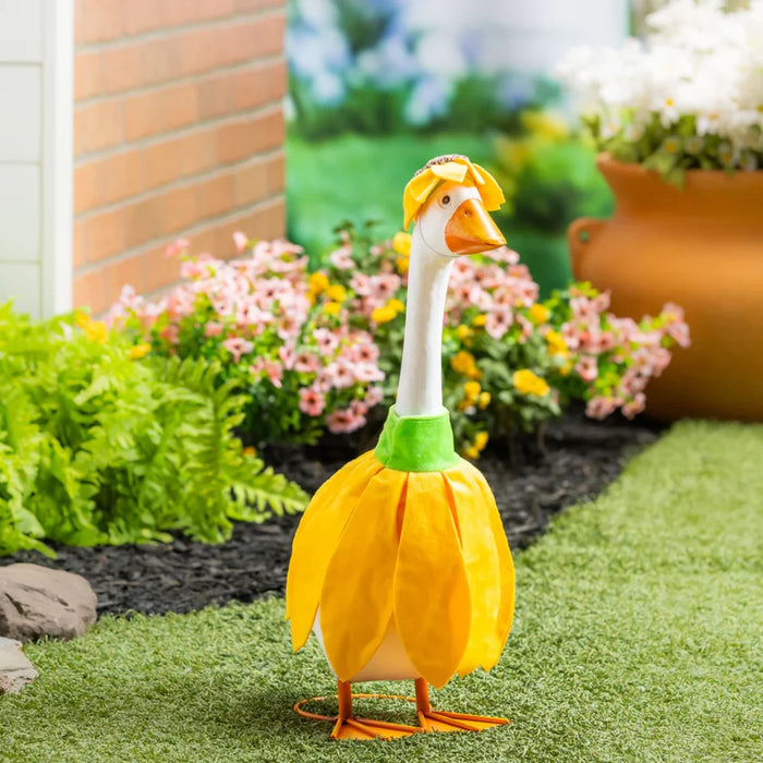 A duck dressed in a colorful dress, standing gracefully on a grassy surface.