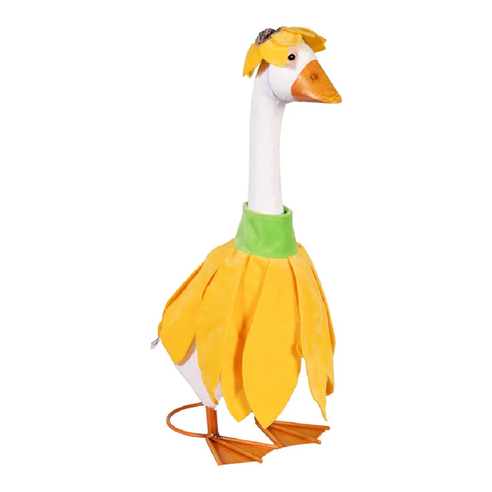 A duck sporting a cute dress, elegantly positioned among greenery.