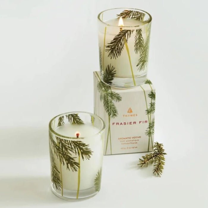Frasier Fir votive candle with pine needle design for cozy seasonal home décor.
