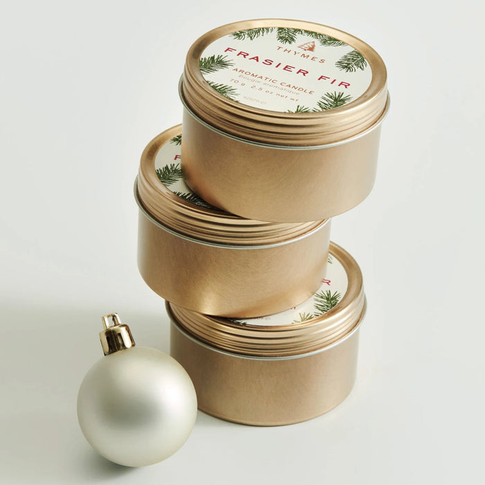 Frasier Fir® Travel Tin Candle with a fresh evergreen-inspired fragrance in a compact travel-size container.