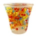 Clear cup filled with colorful water beads on a white background