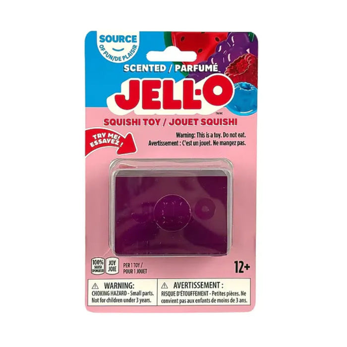Hand squeezing a purple rectangular Jell-O Squishi toy, bending the soft sides around the embossed Jell-O logo.