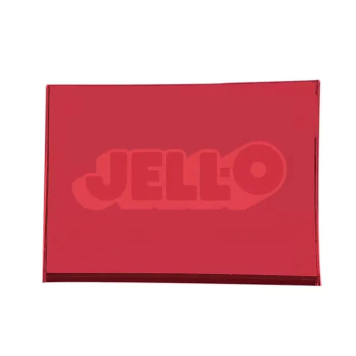 Hand squeezing a purple rectangular Jell-O Squishi toy, bending the soft sides around the embossed Jell-O logo.
