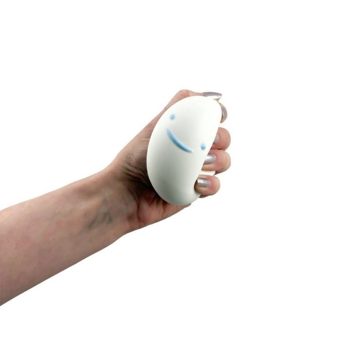 Hand holding a white toy with blue accents on a white background