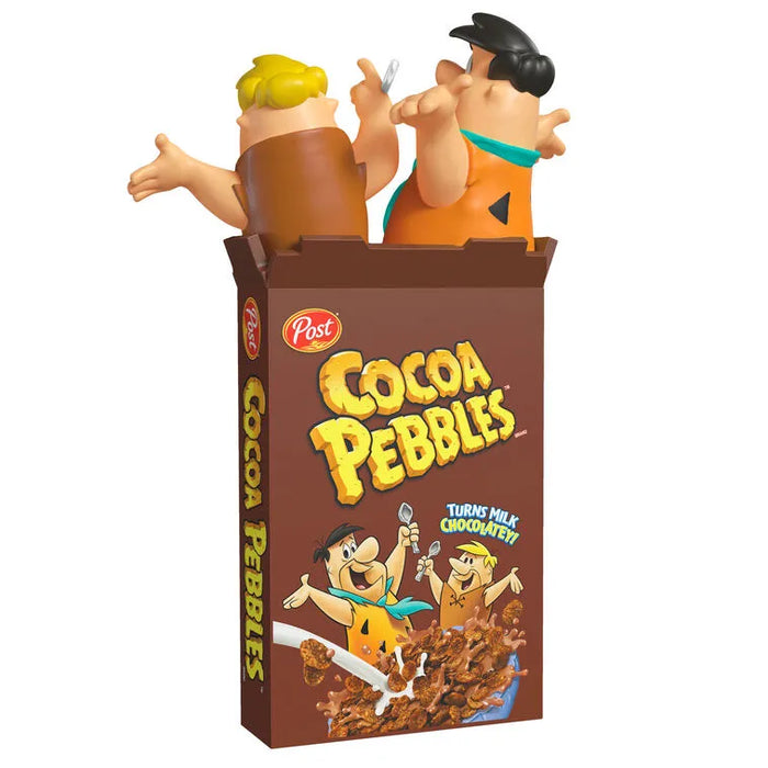 Side angle of Cocoa Pebbles Flintstones Christmas ornament showing vertical logo text and dynamic figurine poses