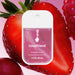Touchland Berry Bliss hand sanitizer packaging with strawberries on a pink background