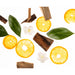 Citrus slices, leaves, and wood pieces on a white background