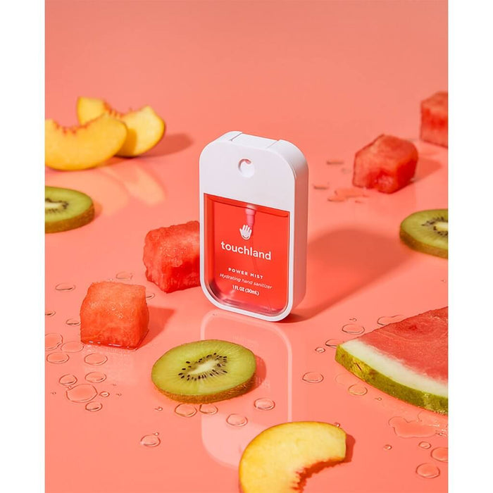 Touchland Wild Watermelon Power Mist hydrating hand sanitizer surrounded by fresh fruit slices.