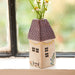 A cozy house with daisies in a vase on the window sill, enhancing the inviting atmosphere of the home.
