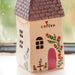 A charming house with a vase of daisies on the window sill, bringing a fresh and lively touch to the setting.