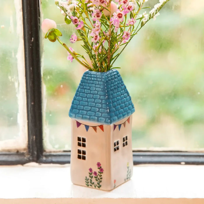 A vase filled with colorful flowers placed on a sunlit window sill, enhancing the room's natural beauty.