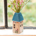 A vase filled with colorful flowers placed on a sunlit window sill, enhancing the room's natural beauty.