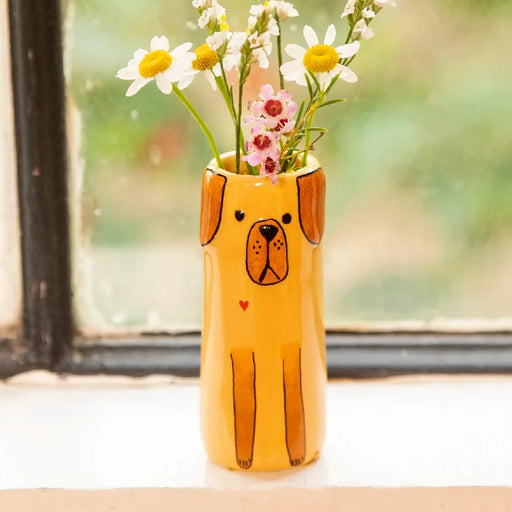A yellow dog-shaped vase filled with fresh daisies, showcasing a cheerful floral arrangement.