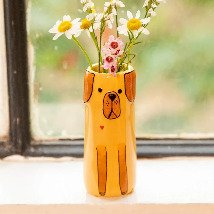 A yellow dog-shaped vase filled with fresh daisies, showcasing a cheerful floral arrangement.