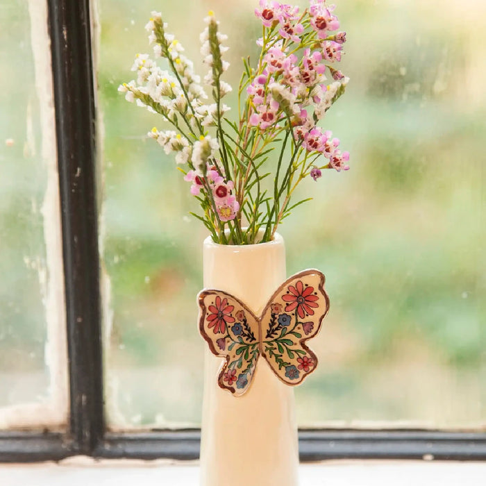 A decorative vase featuring a butterfly design, showcasing intricate details and vibrant colors.