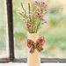 A decorative vase featuring a butterfly design, showcasing intricate details and vibrant colors.