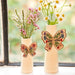 A vase adorned with a butterfly motif, highlighting its artistic craftsmanship and elegance.