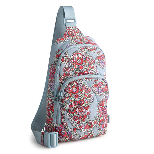 Front view of Vera Bradley Lorman Sling Backpack in Paisley Bouquet featuring bright floral print on light blue background and quilted finish.