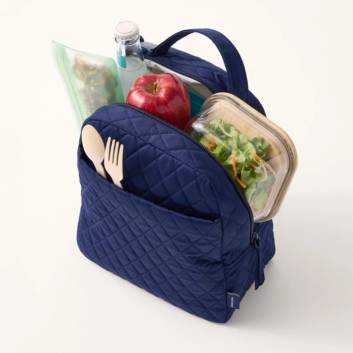 Lifestyle image showing packed lunch items inside Vera Bradley quilted lunch bag.