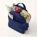 Lifestyle image showing packed lunch items inside Vera Bradley quilted lunch bag.