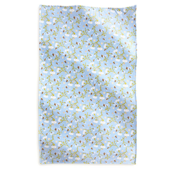 Vera Bradley Plush Throw Blanket fully spread, displaying an all-over print of white flowers and bees on a soft blue fleece background