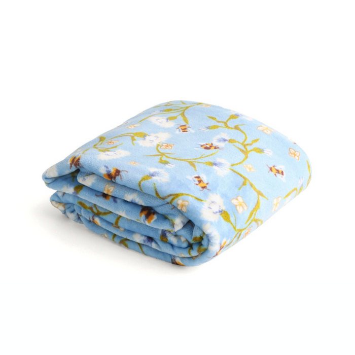 Folded Vera Bradley Plush Throw Blanket in Fleece, featuring a light blue background with white floral and honeybee design.