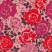 Close-up of Coming Up Roses Pink floral pattern with red and fuchsia roses and dark leaves from Vera Bradley plush throw blanket.