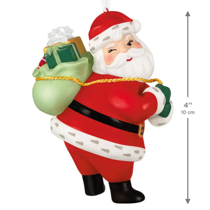 Decorative Santa Claus figurine with a sack of gifts on a white background