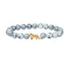 Grey marbled beaded bracelet with a  snow leopard charm on a white background